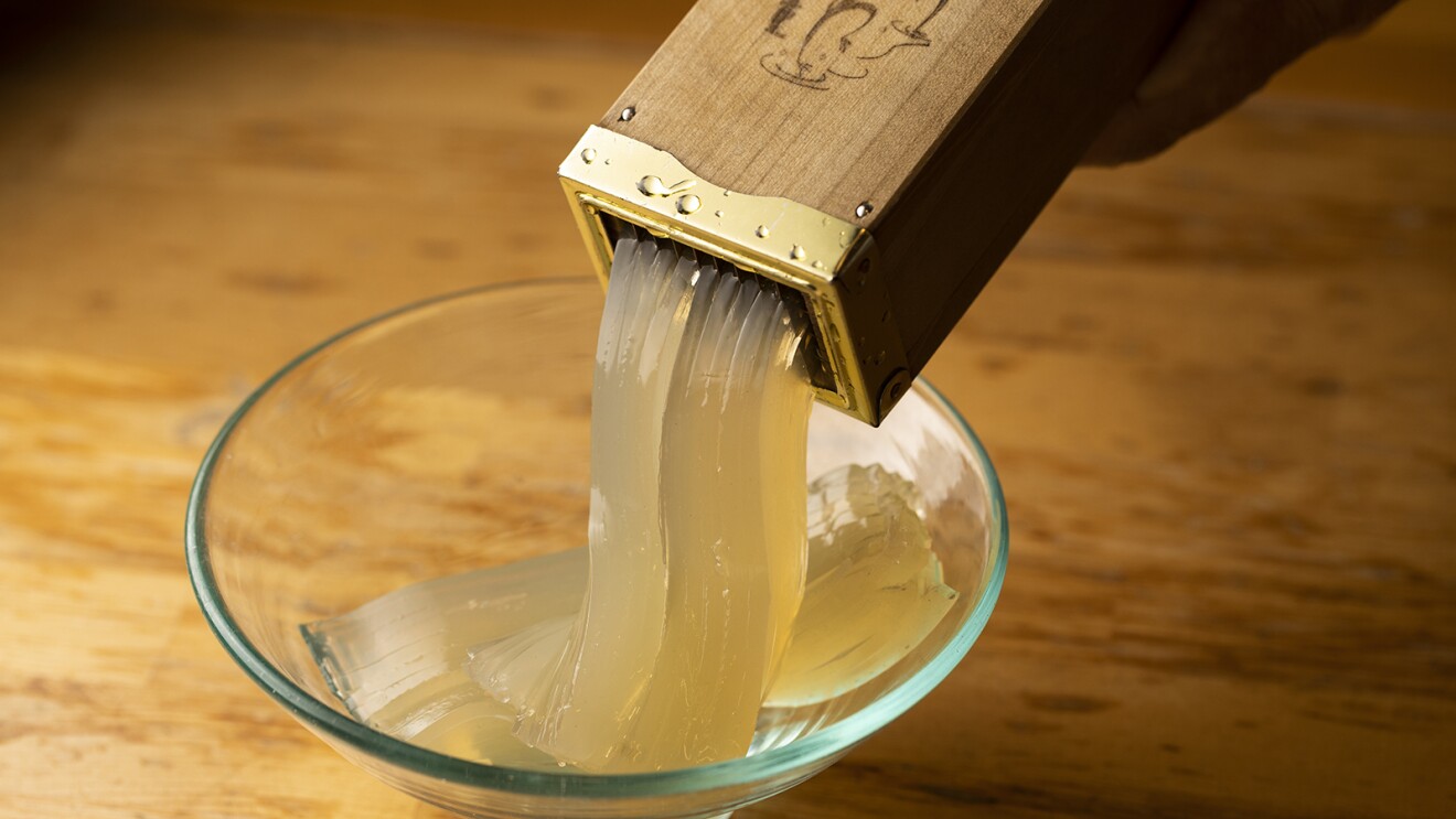 突き棒から麺のように切られたところてんが出てくる写真