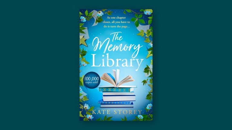 Book cover of 'The Memory Library' by Kate Storey with stacked books and floral border