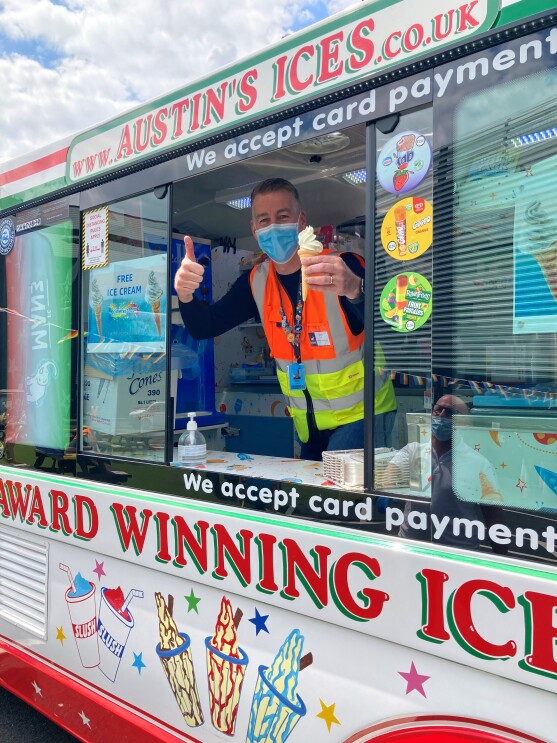 Mark Chew inside ice cream van at MAN3 holding an ice cream