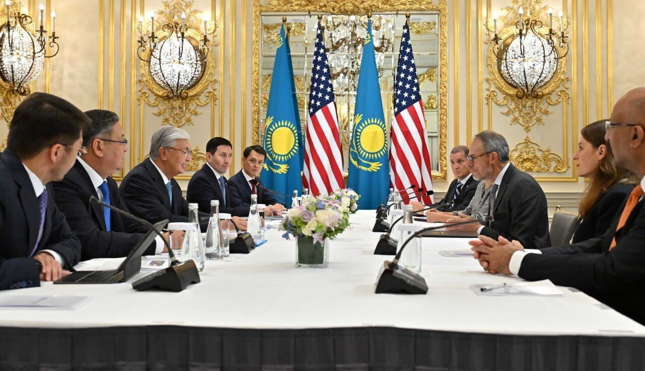 US-Kazakhstan diplomatic meeting with flags and officials seated at table