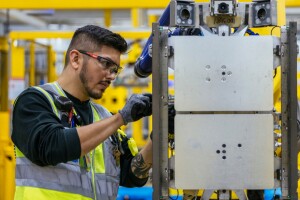 An Amazon employee works in a fulfillment center.