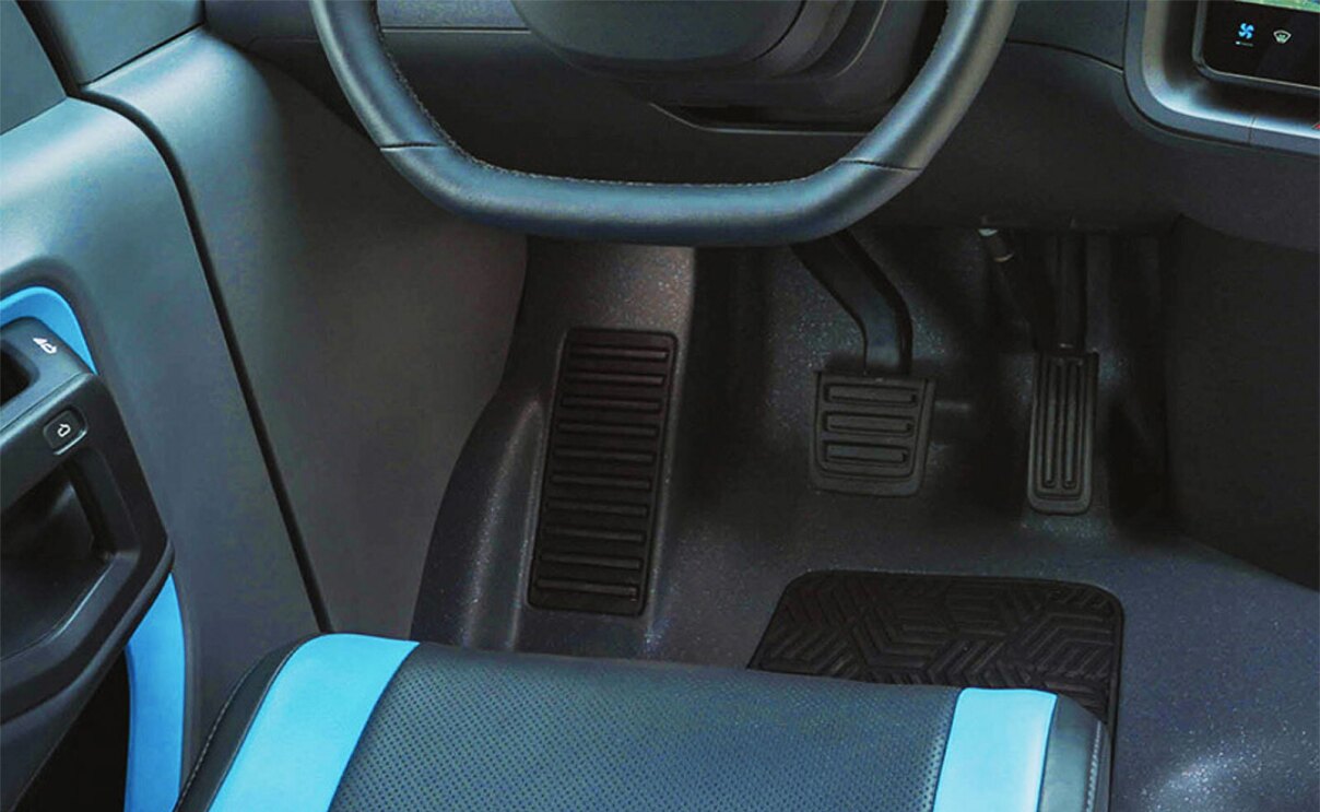 A photo of a brake pedal and gas pedal inside an Amazon delivery van.