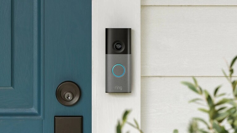 Ring 4K video doorbell mounted next to teal front door