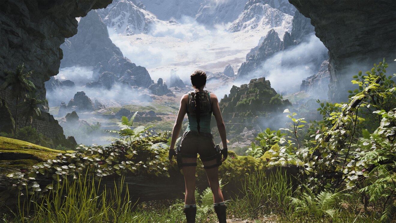 Explorer gazes at misty mountain landscape from cave entrance