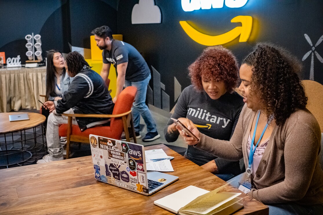 Amazon employees working with colleagues.