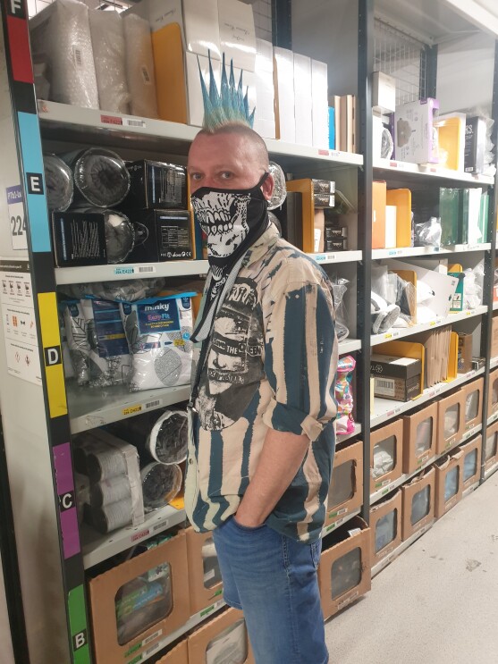 Martyn Janes wearing a facemask and standing in the fulfilment centre.