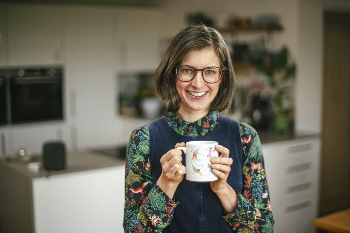 Bethan Thomas, co-founder of HotTea Mama, holding a mug of tea