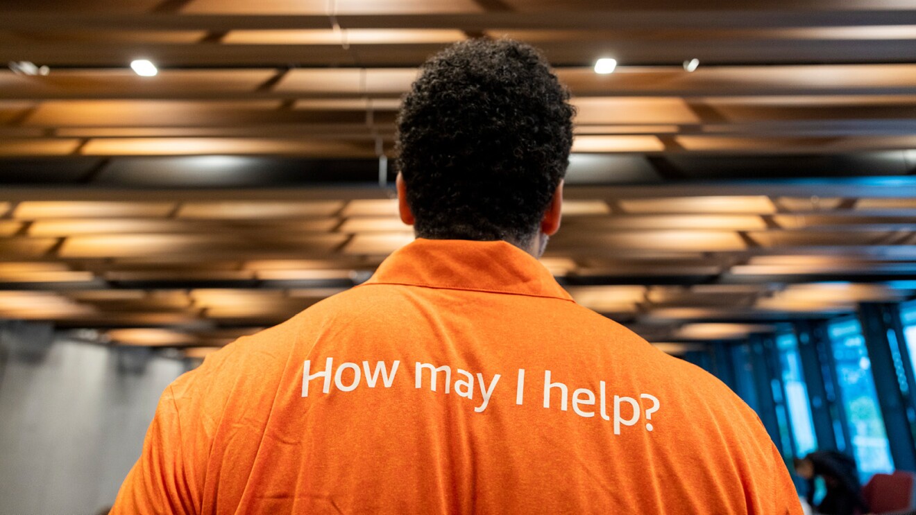 A photo of the back of a Welcome Ambassador in the lobby of Amazon’s Seattle headquarters.