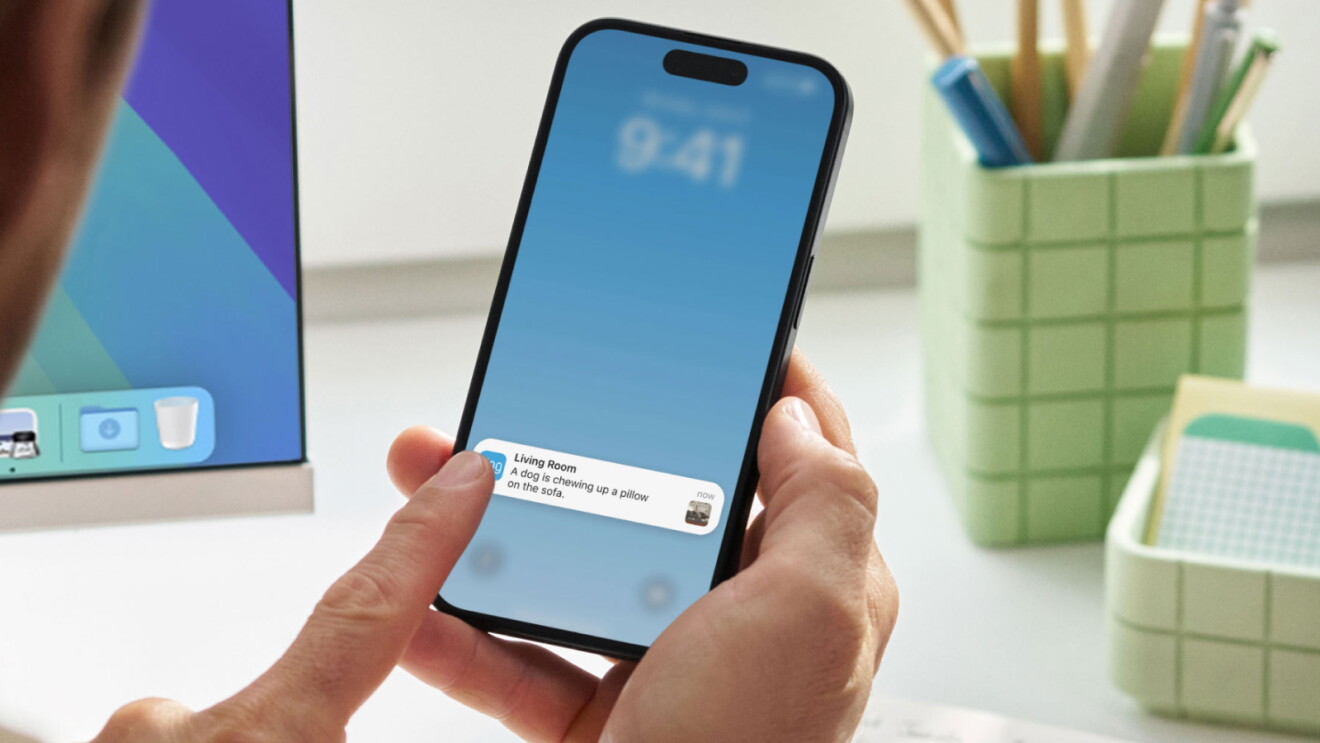 Man holding a phone showing a Ring doorbell notification