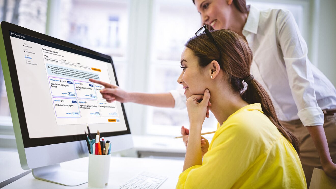 Colleagues collaborating on project management software on desktop computer for Cohorts fun