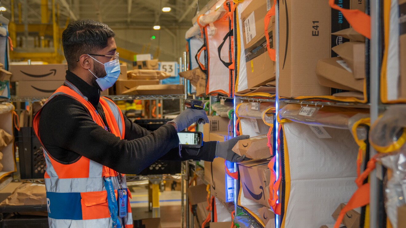 Photos of Amazon associates working in a Fulfillment Center in France.