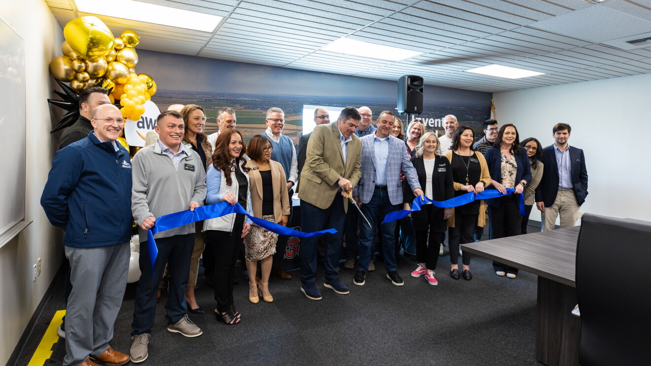 AWS Eastern Oregon blue Ribbon-cutting ceremony with large group at business opening