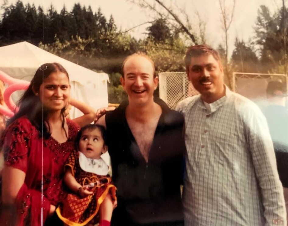 Amazon founder Jeff Bezos poses with Samir Kumar, his wife and their 1-year-old daughter Samika
