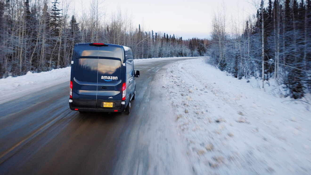 Amazon delivery van navigating snowy rural road