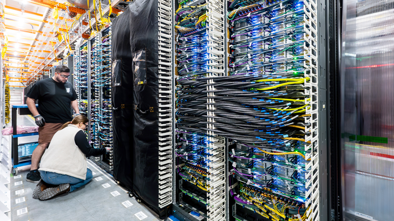 Two technicians working inside a data cener
