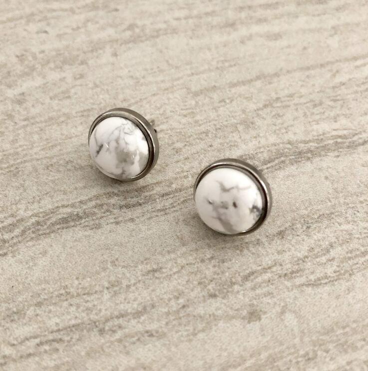 A flat shot of handmade jewelry with raw and semi-precious stones made by T. Victoria.