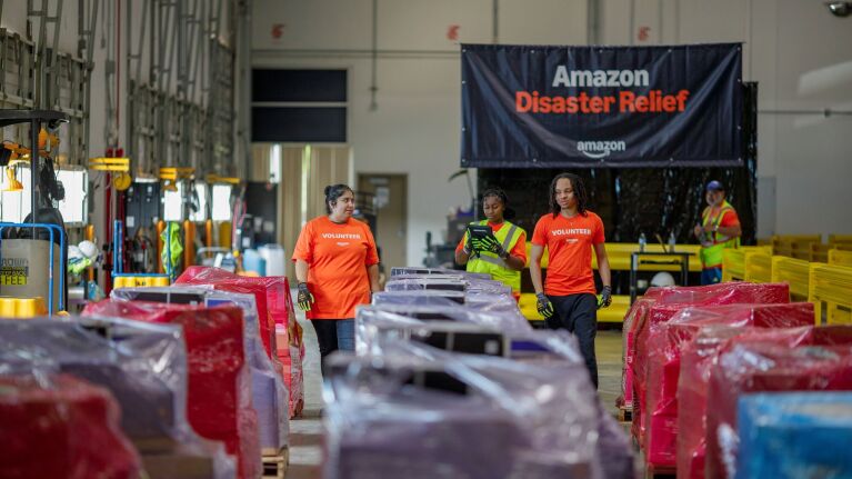 Amazon Disaster Relief volunteers organize supplies in warehouse