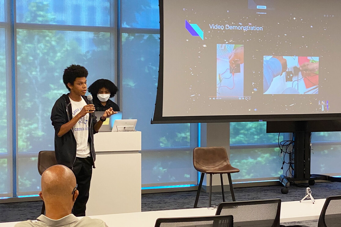 An image of an Amazon Greene Scholars participant giving a presentation.