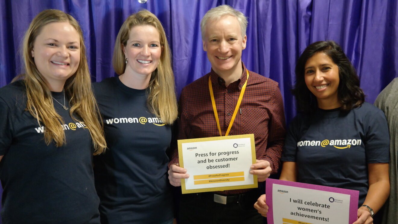 Employees holding certificates at International Women's Day at Amazon