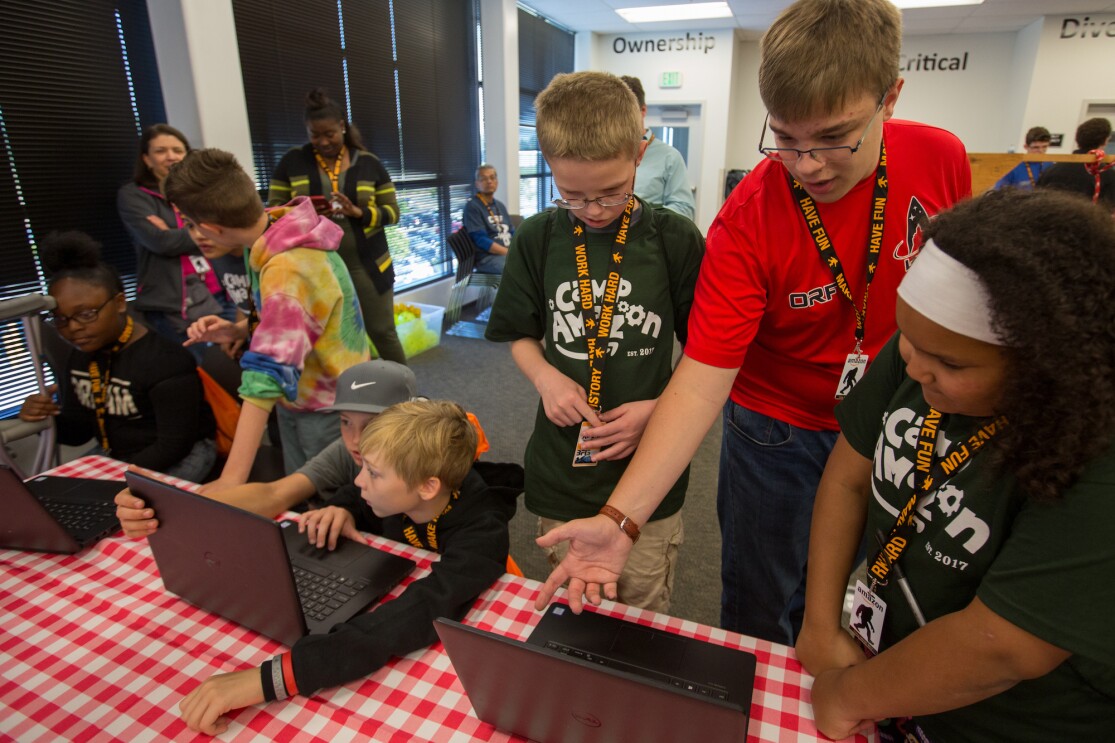 Students participate in a Camp Amazon event at a fulfillment center in Washington