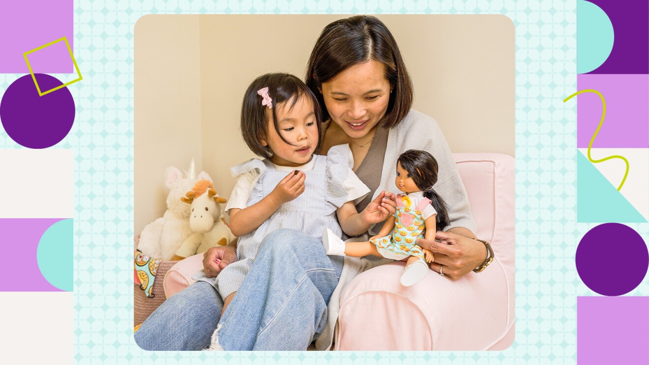 Mother and daughter bonding with toys on a cozy chair