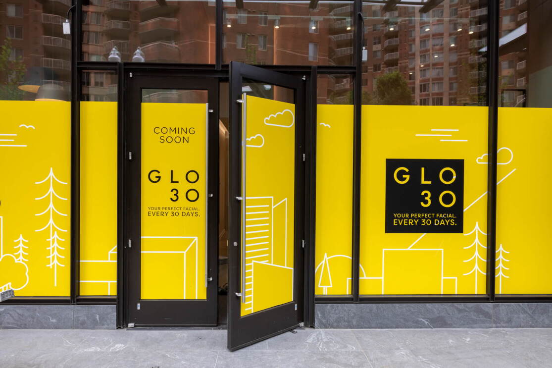 A photo of tall glass windows and an open door of a retail space under construction at the base of Amazon HQ2 at Metropolitan Park in Arlington, Virginia.