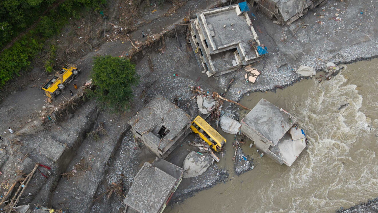 The aftermath of flooding in Nepal, with overturned cars, ruined buildings