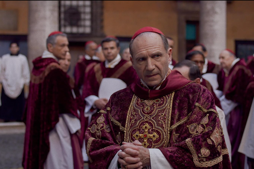 A scene from the Oscar-nominated film, Conclave, shows Ralph Fiennes looking pensive