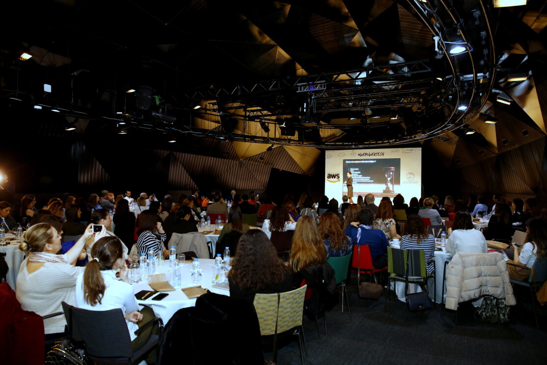 Back of the room point of view of women listening to the conference