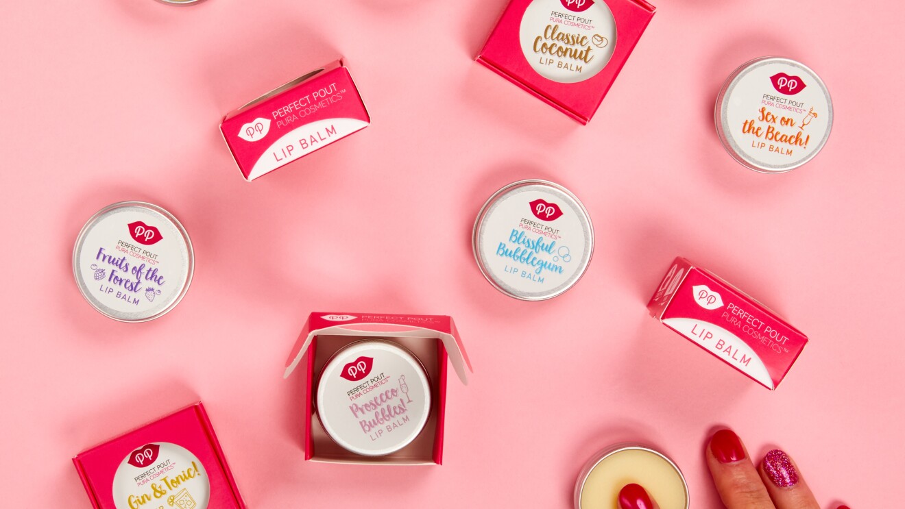 An image of the Pura Cosmetics large lips products in a pink table with someone using one of the products.