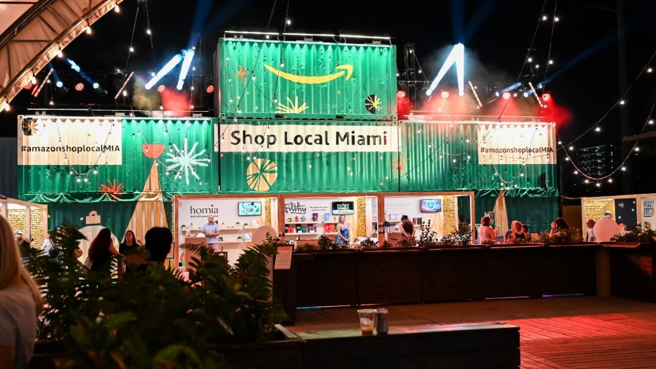 Sellers sit at their booths at the holiday Shop Local Miami event.
