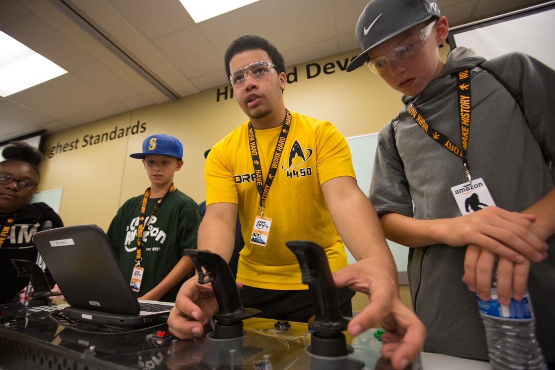Students participate in a Camp Amazon event at a fulfillment center in Washington