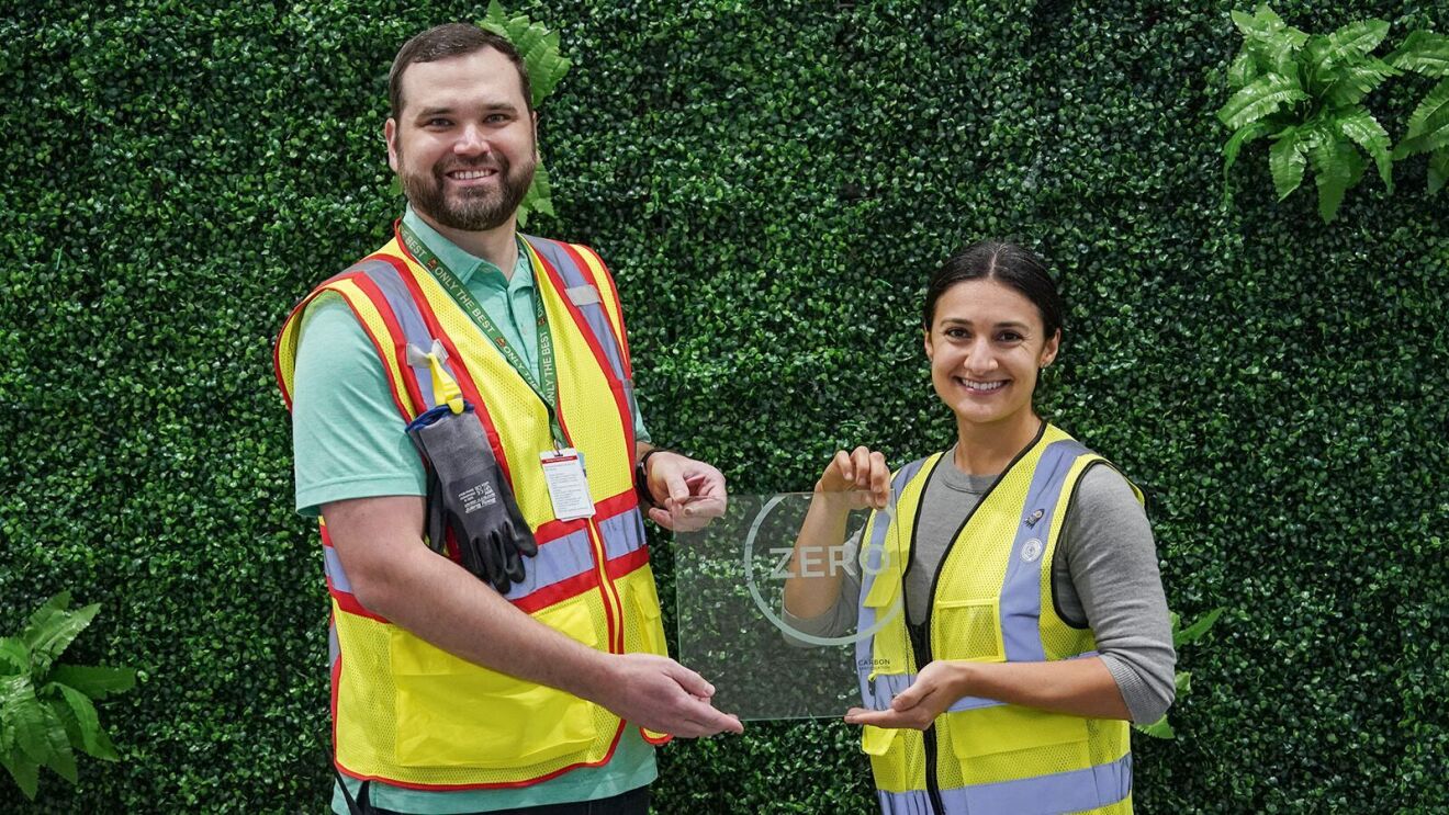 Employees in safety vests posing outside