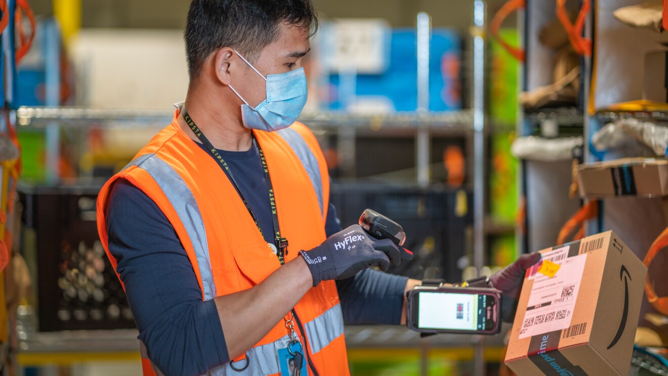 Photos of Amazon associates working in a Fulfillment Center in France.