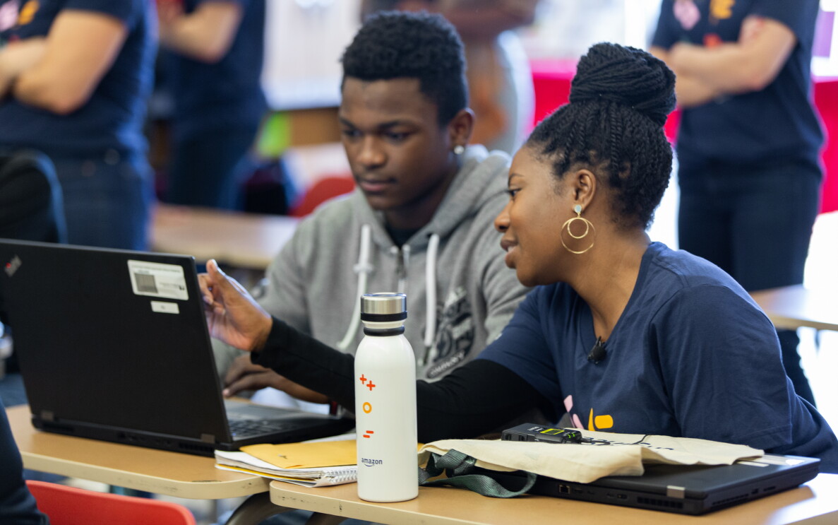 Amazon employee volunteers work on coding projects with students at Dunbar High School in Washington, DC to celebrate Amazon Future Engineer's 2,000 high schools milestone.