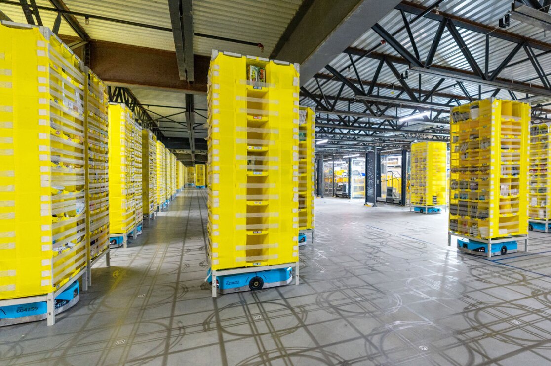 Amazon robots are on their individual tracks bringing products throughout the fulfillment center.