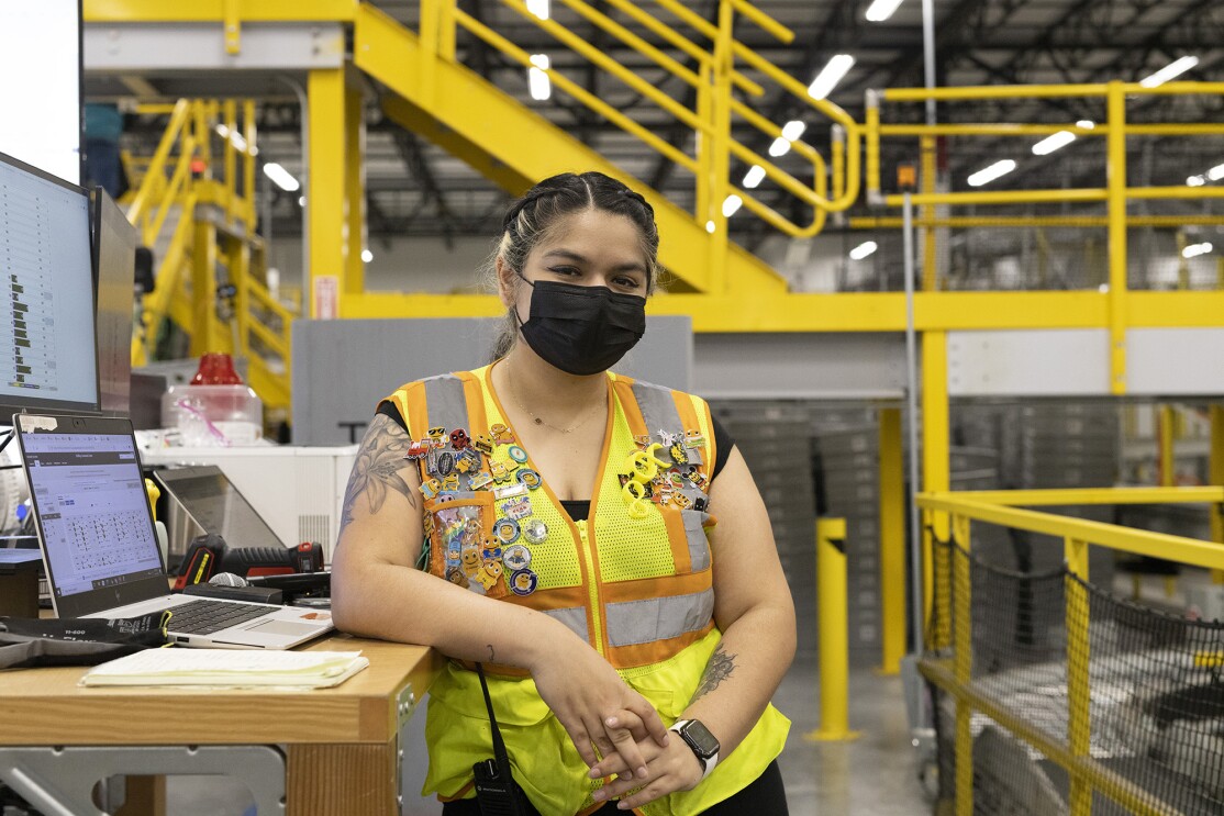 Amazon employee Brisa at work. Brisa received paid parental leave support from Amazon (up to 20 weeks) when she recently gave birth to her child.