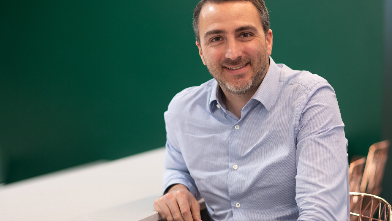 Guillaume sitting in office workspace