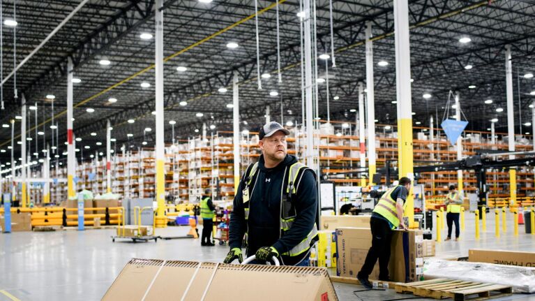 Industrial warehouse scene with employees processing packages