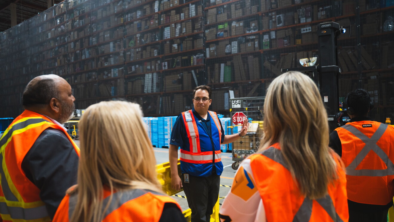 Guests listening to a tour guide behind the scenes at YVR3.