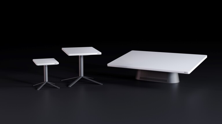 Three white modern tables of varying sizes on dark background