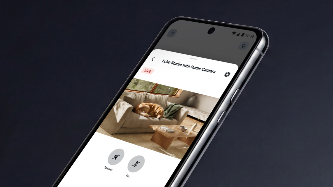 A camera recording of a living room on a phone view of Echo Studio with Home Camera.