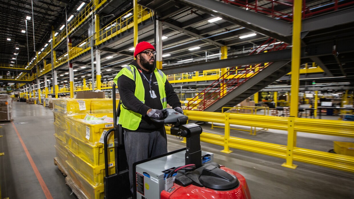 Employee moving crates around the fulfillment center