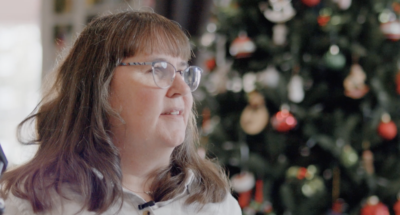 An image of Anne, an Amazon customer, with a Christmas tree in the background. 