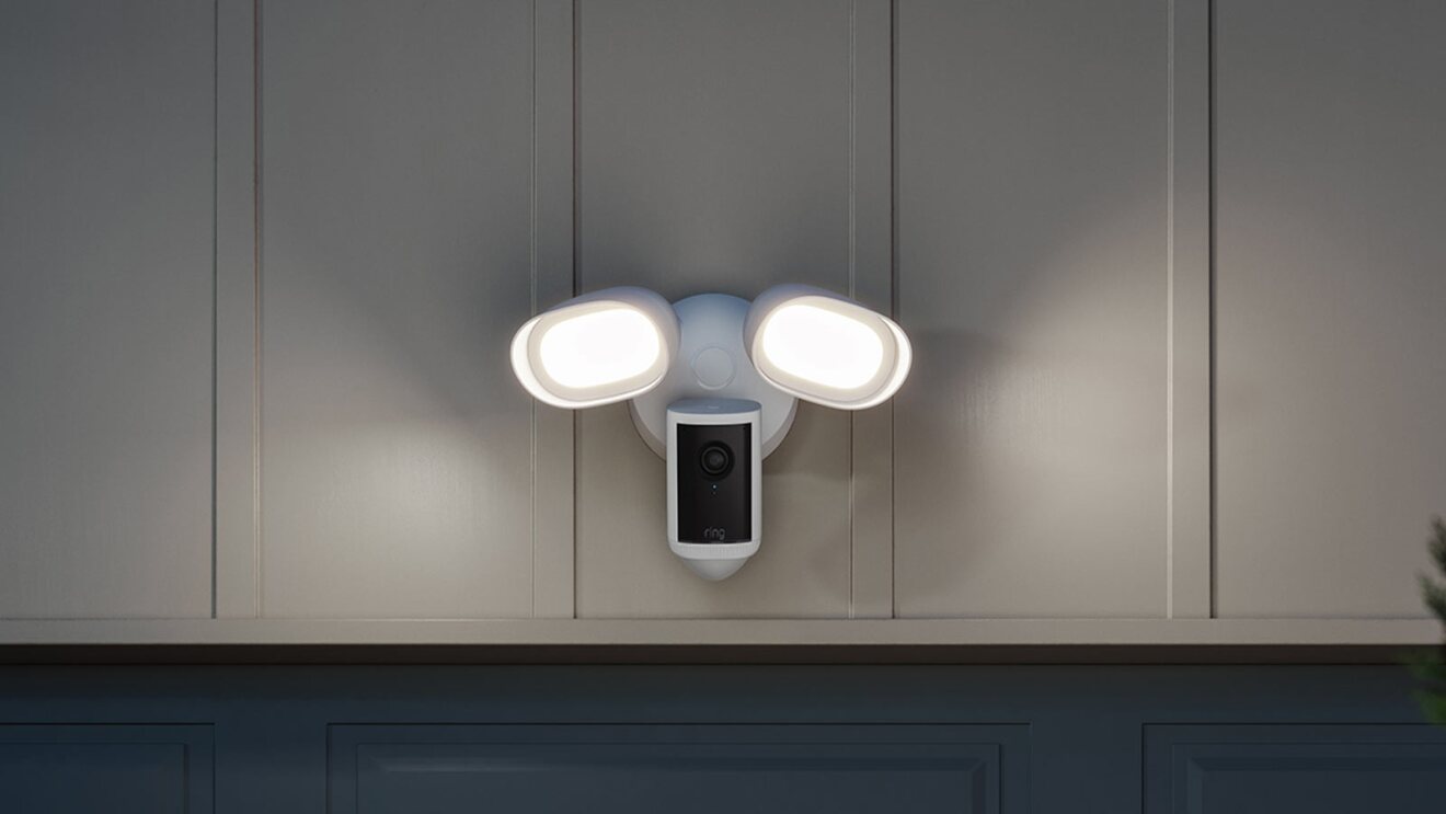 Smart security floodlight with integrated camera mounted on wall
