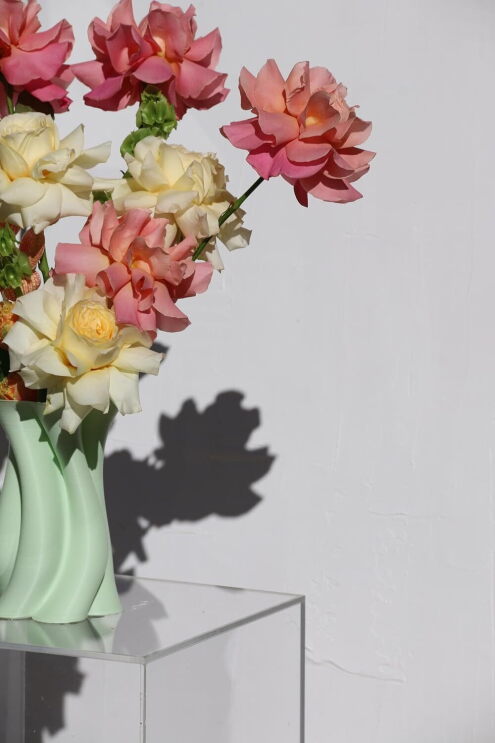 A Belfi vase holding colourful flowers.