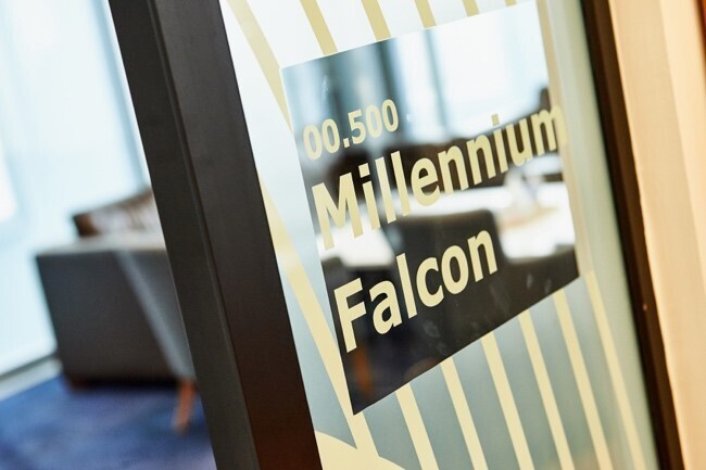 Door of a meeting room at Amazon’s Development Centre Scotland with the name Millennium Falcon