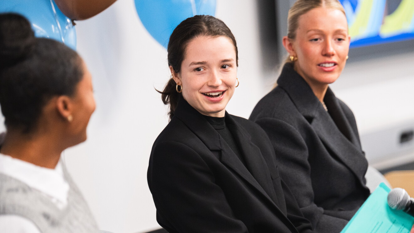 women speaking at event 