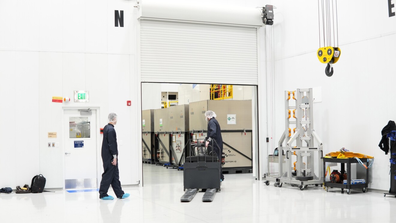 Amazon Leo production facilityshowing workers near large containers