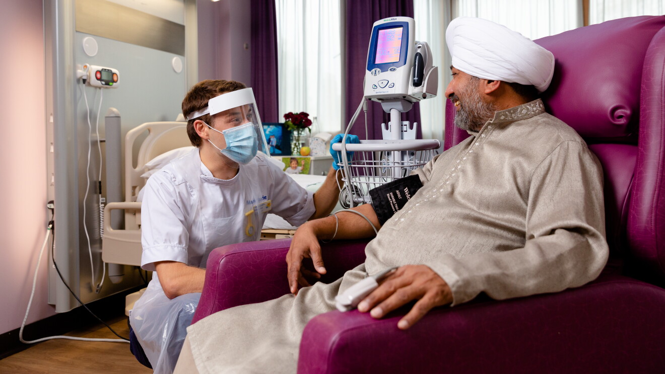 nurse in ppe with patient